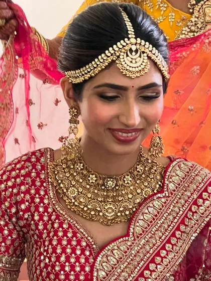 The bride looking stunning with her elegant updo and beautiful gold jewelry.