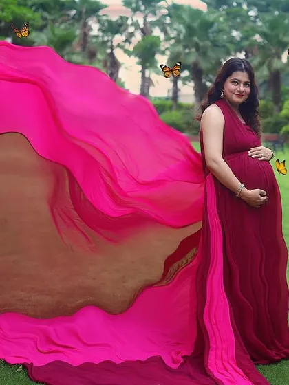 Let's create a fairytale moment for you. In this outdoor maternity photo, we used a flowing gown to create magical butterfly wings, celebrating the beautiful transformation of motherhood.