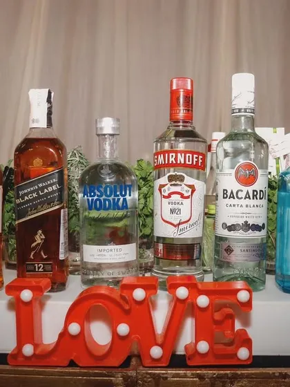 We stock a full range of premium spirits to cater to all tastes. The 'LOVE' sign is a fitting centerpiece for a wedding celebration bar.