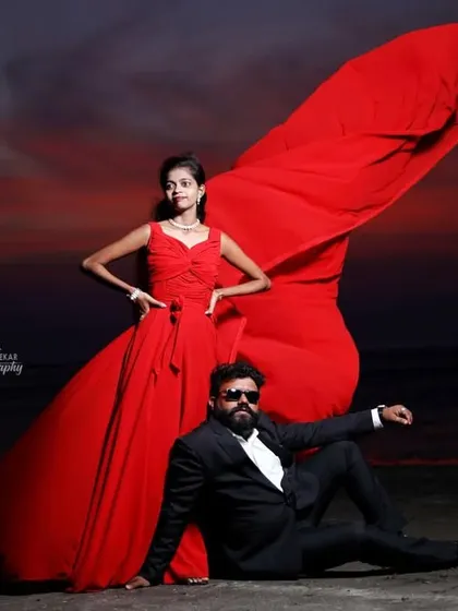 Our dark red gown with a cross-pleated bodice and a long flowing tail is a bold and beautiful option for any photoshoot.