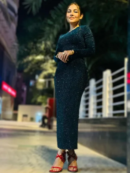 A full-length shot of a client ready for a launch event. I provided a sleek ponytail and polished makeup to match her sparkling dress.