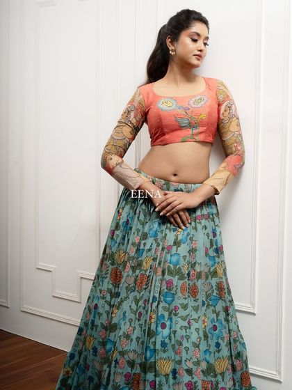 Discover the beauty of traditional craftsmanship with this stunning Pen Kalamkari lehenga. The piece is meticulously hand-painted by my artisans, with a story unfolding on the blouse sleeves and a beautiful floral pattern on the skirt and dupatta.