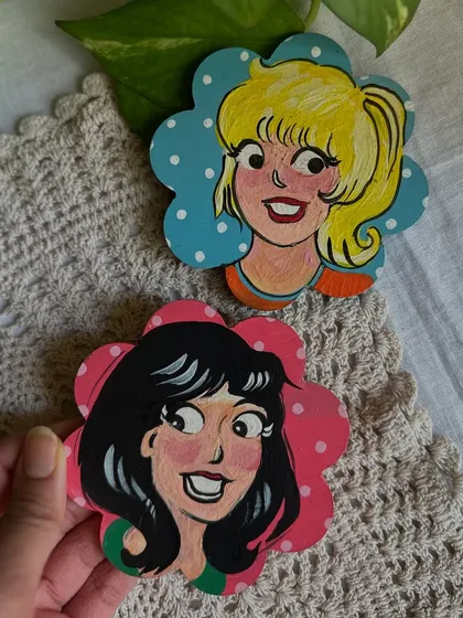 A nostalgic set of magnets featuring Betty and Veronica from the Archie comics, painted in my style.