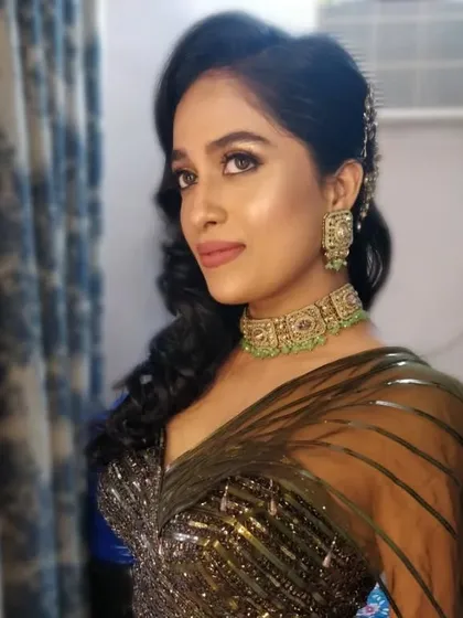A close-up portrait showing off the beautiful side-swept hairstyle and the soft, glowing makeup. This look was perfect for her engagement celebration.