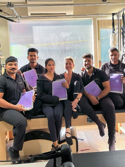 Our team proudly displaying their training manuals. We are committed to continuous education to provide the highest quality instruction.