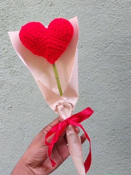 A single heart bouquet, held in hand. These are lightweight and make for a very cute and thoughtful gift.