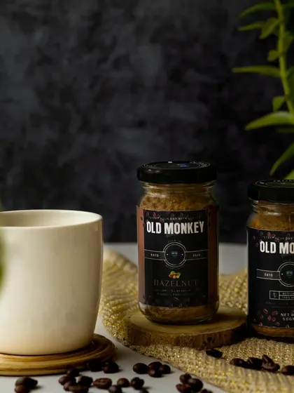 I love when clients give me full creative liberty. For this coffee shoot, I created a moody scene with two jars of coffee, a ceramic mug, and natural elements against a dark, textured background.