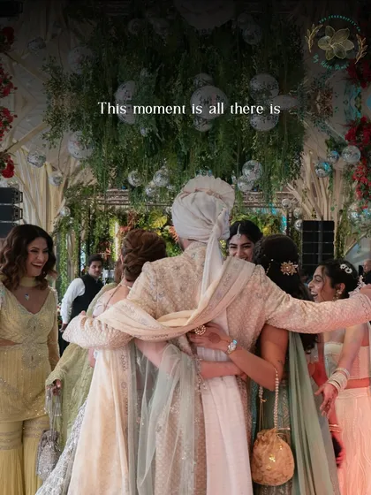 "This moment is all there is." A groom embraced by his loved ones, a perfect capture of what weddings are all about.