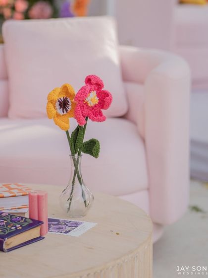 Every tiny detail is perfectly placed to create a magical atmosphere. These whimsical crochet flowers in a vase added a unique, handmade touch to the "Bloom" wedding decor.