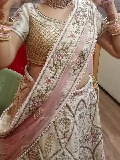 A candid shot of a client trying on her outfit. The rental choker and bangles are the finishing touches that tie her entire wedding day look together.