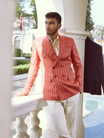 Effortlessly chic in brick red linen with cream stripes. Elevate your look with cream linen pants for a sophisticated ensemble.