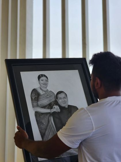 Holding up the large, framed couple portrait. The scale of an A1 piece makes a significant impact in any room.