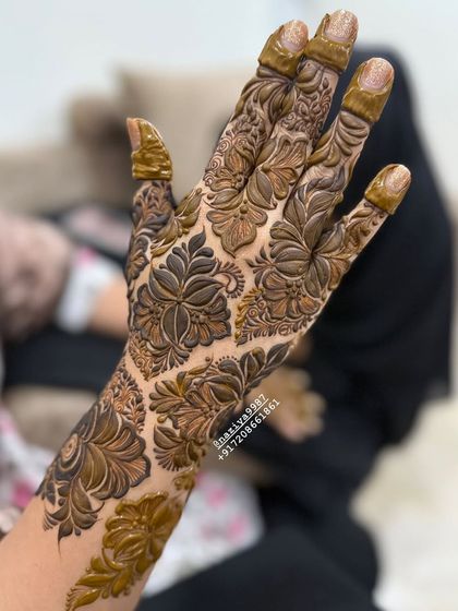 Another angle of the full-hand floral design, showing how the pattern wraps around the hand and fingers.
