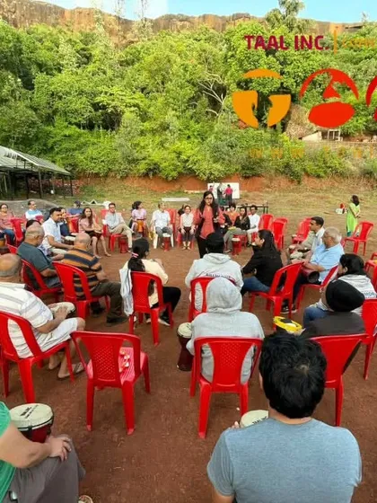 We can create a drum circle anywhere. Here's one of our facilitators leading a family session in a beautiful, open-air venue just outside Pune. The natural setting adds another layer of peace and connection to the experience.