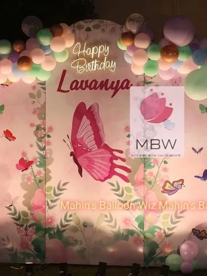 A straight-on shot of the pastel butterfly backdrop, perfect for capturing beautiful photos of the birthday celebration.