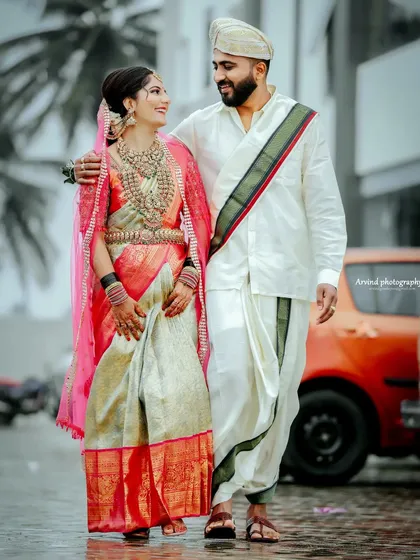 I love capturing the blend of tradition and modern love. This couple, walking hand-in-hand in their stunning wedding attire, with a vintage car in the background, creates a unique and stylish wedding portrait.
