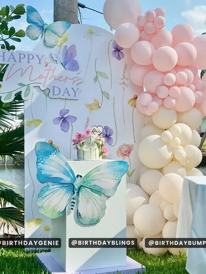 A beautiful setup for Mother's Day, featuring a butterfly and floral-themed backdrop. This shows how I can create decor for any special occasion.