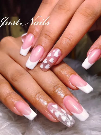 A playful twist on the classic French manicure. This design on long, square-shaped nails features a sheer accent nail with encapsulated white hearts.
