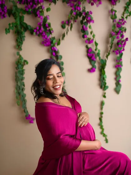 A close-up of her happy smile. The vibrant colors of her dress and the flowers perfectly complement her joyful expression.