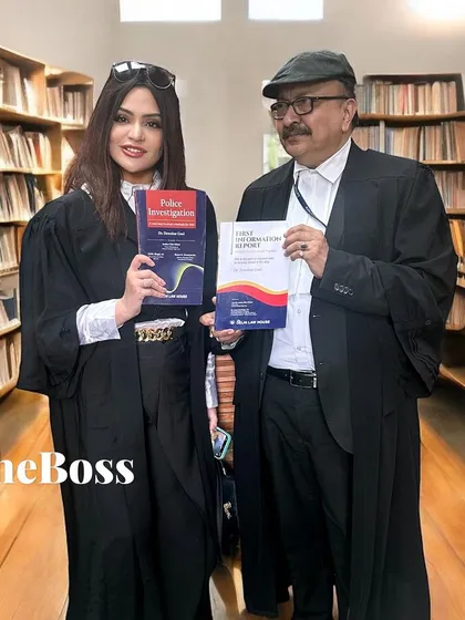 Holding a copy of a newly launched law book with a colleague in the Supreme Court library. Continuous learning is essential for every advocate.