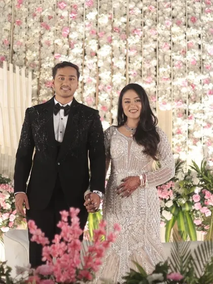 The couple making their grand entrance. The bride's makeup is flawless and photo-ready, ensuring she looks stunning in every picture.