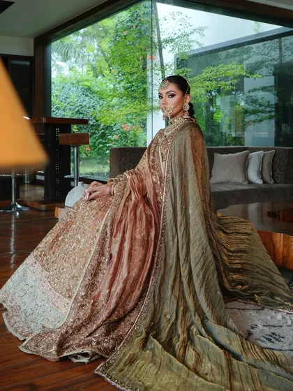 A dramatic shot showcasing the full effect of the double dupatta draping. The velvet shawl adds a layer of texture and royalty to the ensemble.