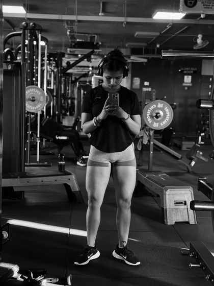 A black and white shot focusing on leg development. Using resistance bands is a great way to activate the glutes and leg muscles before a heavy lifting session.