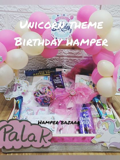 A dreamy unicorn-themed birthday hamper for Palak, decorated with a balloon arch and filled with goodies for a girl.
