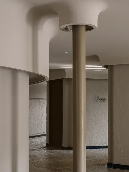 An interior detail of the Aqua spa, showing the soft, curved forms of the walls and columns that continue the organic design language from the outside in.