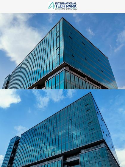 A low-angle shot of a glass-facade building at ITPL against a clear blue sky. We use creative angles to make architectural features stand out.