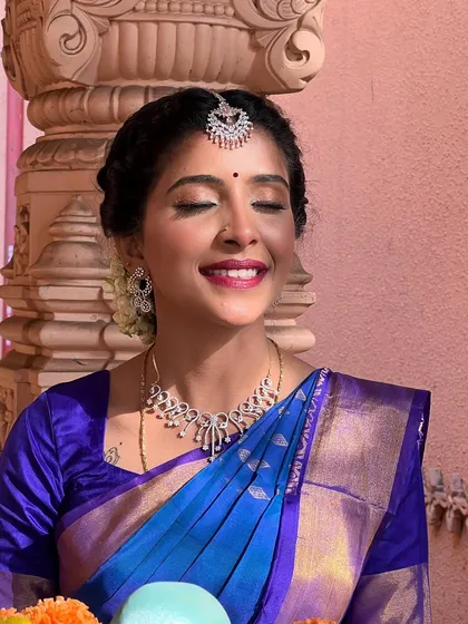 A joyful, smiling shot that captures the essence of a happy bride. The makeup is designed to be radiant and long-lasting, ensuring she looks flawless throughout her special day.