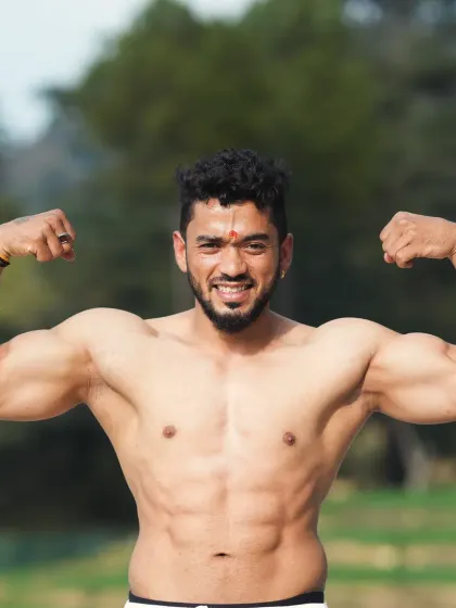 A confident, smiling pose outdoors. Fitness should make you feel strong and happy in your own skin.