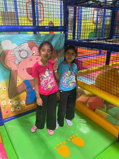 Posing for a picture inside the play maze. The colorful backdrops make for great photo opportunities.