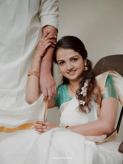 An elegant portrait of the bride seated, her hand resting on her groom's arm, a picture of grace and love.