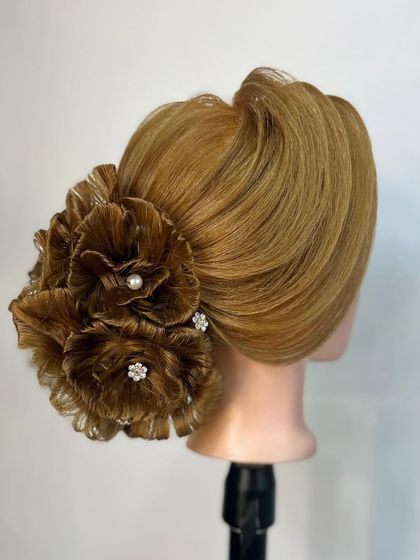 Another angle of the stunning floral hair sculpture, showcasing the precision and artistry taught in our advanced courses.
