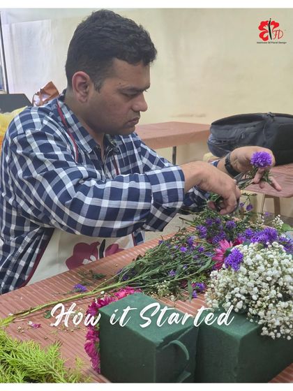 A student is focused on the details of his mini Ganpati arrangement. This image captures the hands-on process of selecting and placing each bloom to create the final design.
