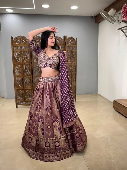 A dynamic pose showcasing the full skirt and the beautiful drape of the matching purple dupatta.