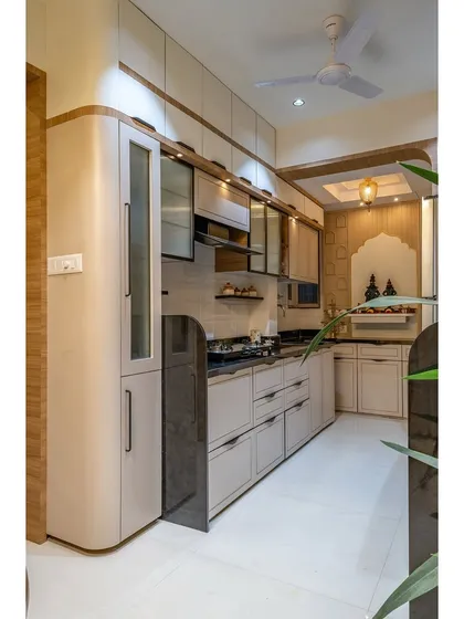 A modern kitchen featuring a mix of wood-look and neutral-toned cabinets. The curved corner cabinet softens the lines and adds a unique design element.