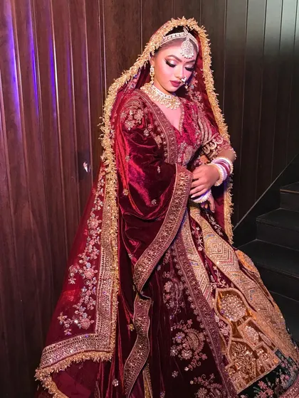 A side profile of the doli motif lehenga, highlighting the flow of the double dupattas.