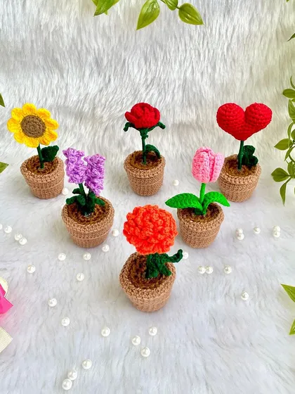 A collection of my different potted flowers, including a sunflower, rose, heart, tulip, lavender, and carnation. You can create your own little crochet garden.