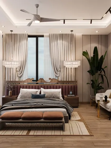 This bedroom at Amaryllis, Karol Bagh, is where elegance meets tranquility. The design features a unique carved headboard, warm wood flooring, and a cozy seating nook, creating a space that feels both stunning and homely.
