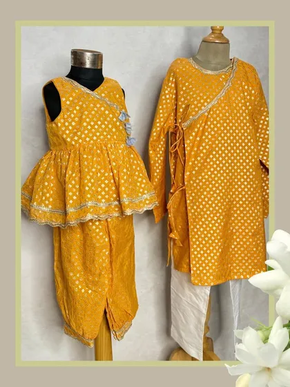This vibrant yellow set is perfect for Haldi functions or festive celebrations. The girl's outfit is a peplum top with dhoti pants, while the boy wears a matching angrakha-style kurta.