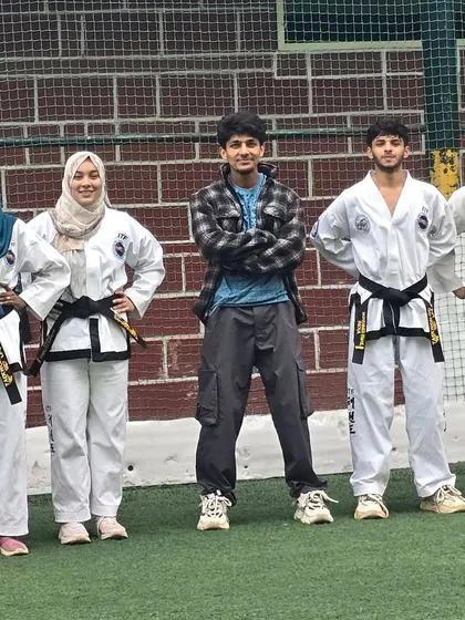 A group of my senior black belt and red belt students, both male and female, standing together as leaders of the XMF team.