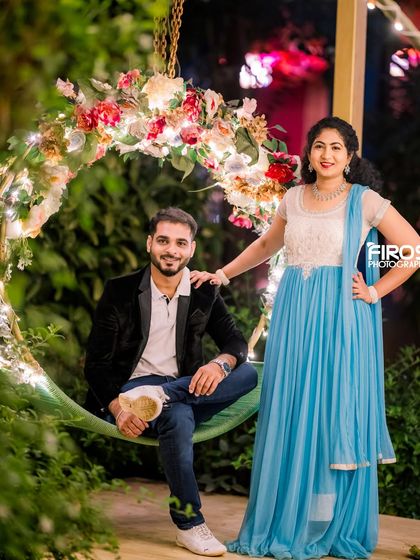 A stylish portrait of a couple on our floral swing, showcasing the magical ambiance of the venue after dark.