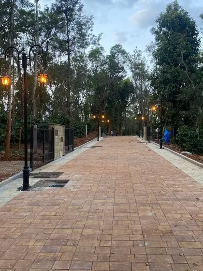 The newly laid cobblestone road at our Sakleshpur project, lined with classic-style lamp posts.