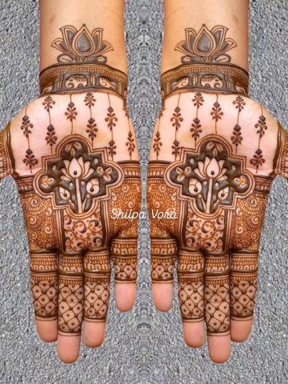 A symmetrical design with a central lotus motif, featuring negative space to create a modern yet traditional feel.