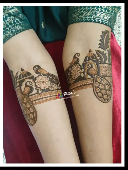 The startup design for the arms, featuring elegant peacocks and architectural jharokha patterns. This is the beginning of a beautiful and elaborate bridal piece.