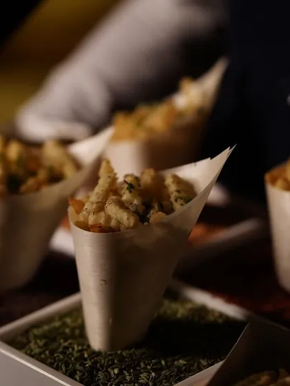 Crispy, seasoned fries served in individual paper cones for a gourmet touch.