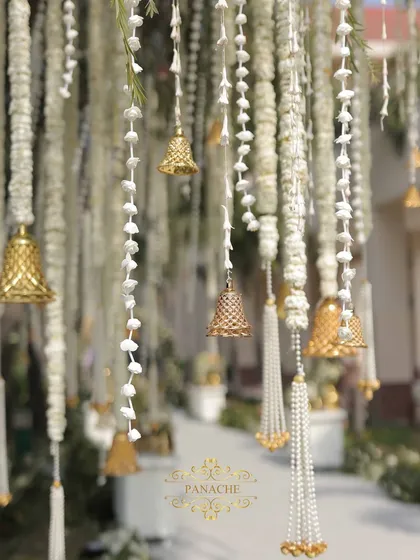 A close-up of the beautiful hanging decorations, featuring strings of white flowers, pearls, and golden bells that tinkled in the breeze.