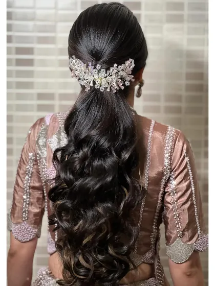 A view of the chic and modern ponytail, adorned with a crystal hair accessory.